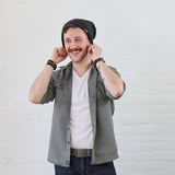 Man wearing charcoal beanie folded up with cuff. Styled casually with denim. Hat fits any size
