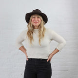 Dark espresso brown hat with floppy flexible brim, modeled on a woman. Casual everyday wear