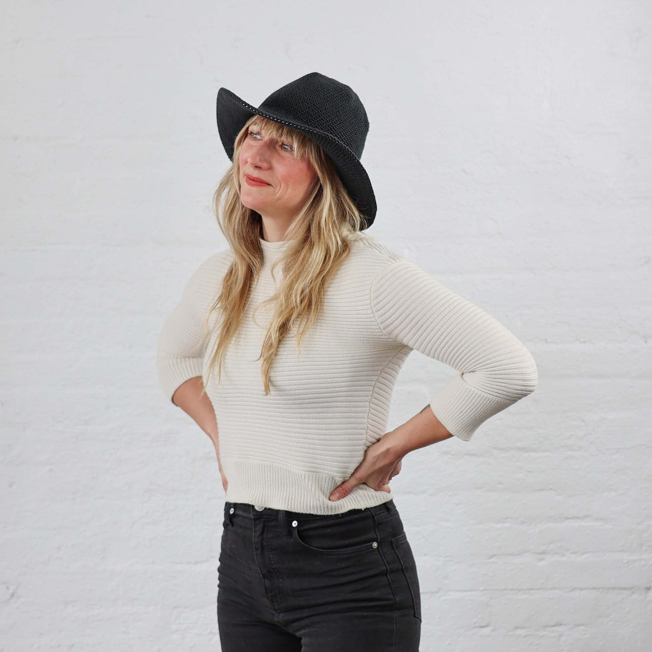 Black Wide Brim Floppy Brim Crochet Sun Hat models on woman with blond hair