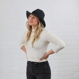 Black Wide Brim Floppy Brim Crochet Sun Hat models on woman with blond hair