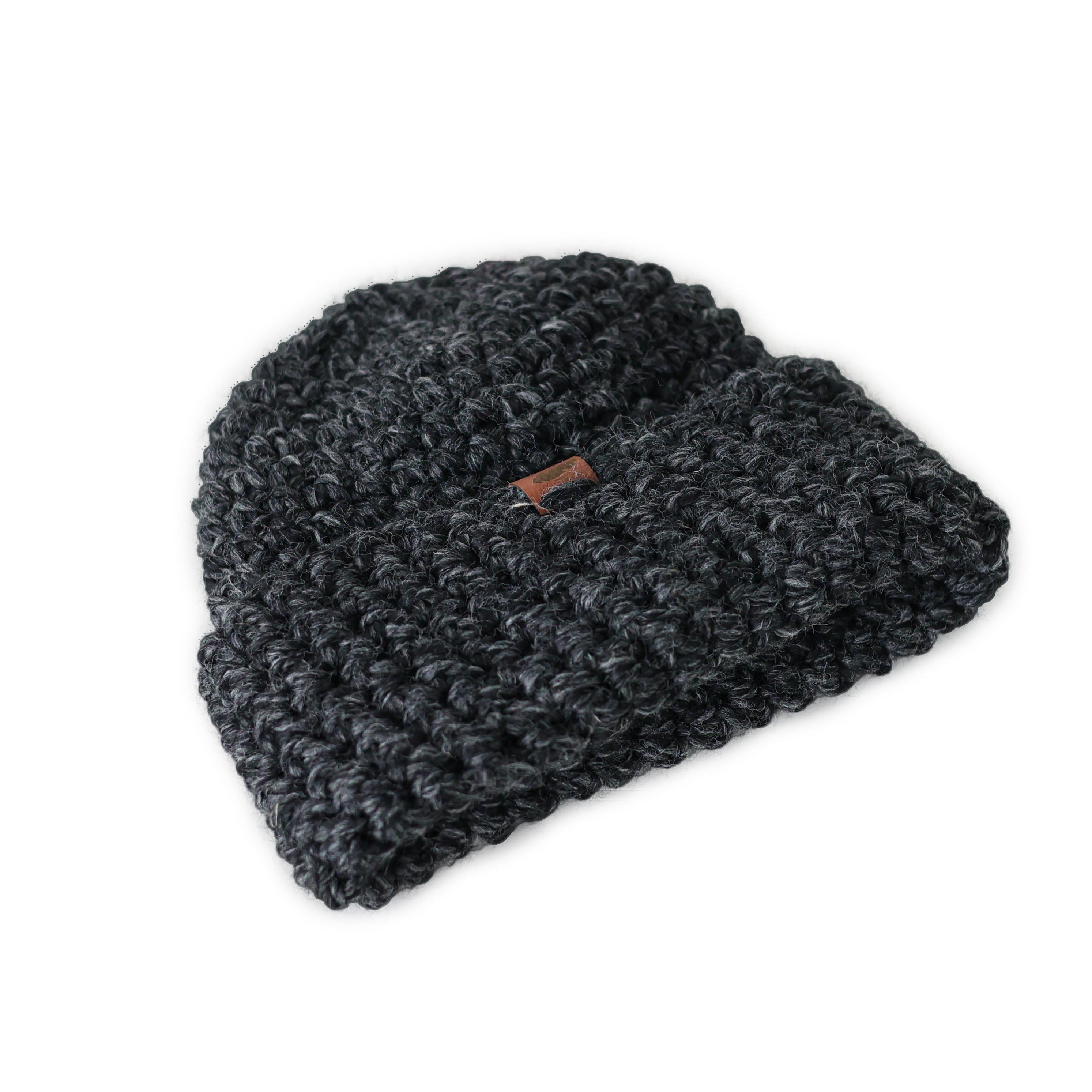 charcoal hat, folded up cuff, sitting flat. has a heathered black color and leather fold over tag