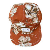 Top View of the 5 panel Flat brim cap style in orange autumn off white floral print, and bold white stitching 