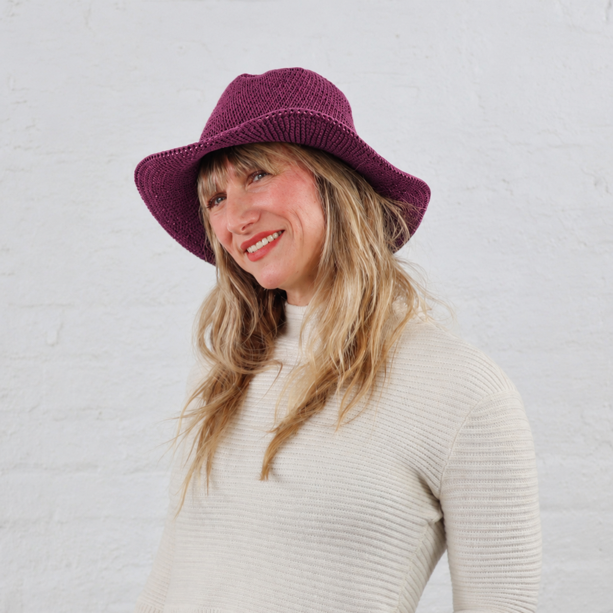 New Aster Purple Hat Color at North Ferry Hats, shown here on a White female model who loves sustainable fashion