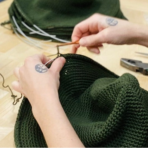 NY MADE Ithaca Workspace of artisans crocheting North ferry Sun hats. 