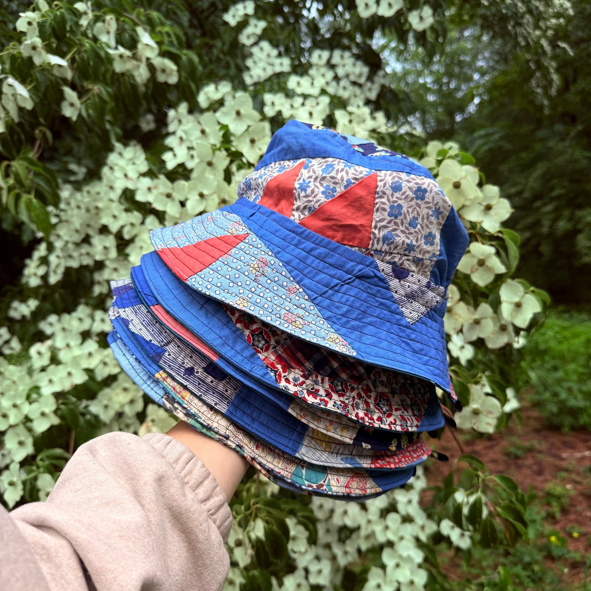 A Stack of Quilted Bucket Hats made from Upcycled Quilts and vintage fabrics.