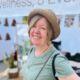 Woman modeling our Crochet Bucket Hat with the brim flipped up. Very cute on short hair styles 