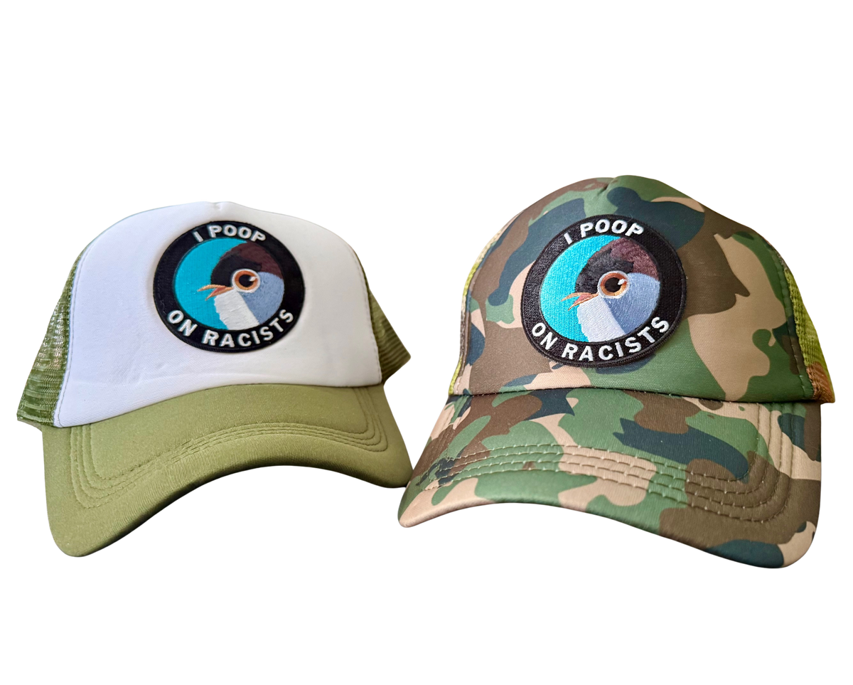 Two hats, one white and green, the other camouflage, with a common design element. North Ferry Hats Finger Lakes NY Camo Print and Green Mesh Trucker Cap and Bird Lab of Ornithology Cornell 