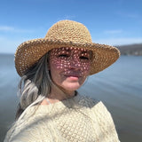 Olivia Ashline of North Ferry Hats in Ithaca NY wearing the new North Ferry Packable Straw Hat, a lightweight raffia crochet packable Sun hat that fits all sizes