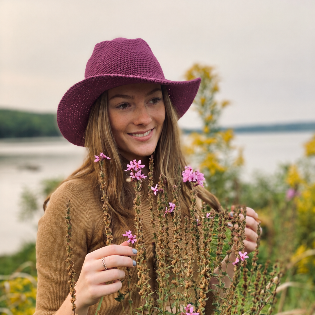Woman wearing a Purple Cowboy North Ferry Hat with a wide brim. Lightweight Cotton Packable Hat that can be worn in all seasons. Winter Wide Brim Purple Hat