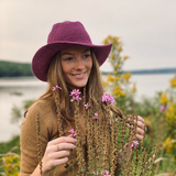 Woman wearing a Purple Cowboy North Ferry Hat with a wide brim. Lightweight Cotton Packable Hat that can be worn in all seasons. Winter Wide Brim Purple Hat