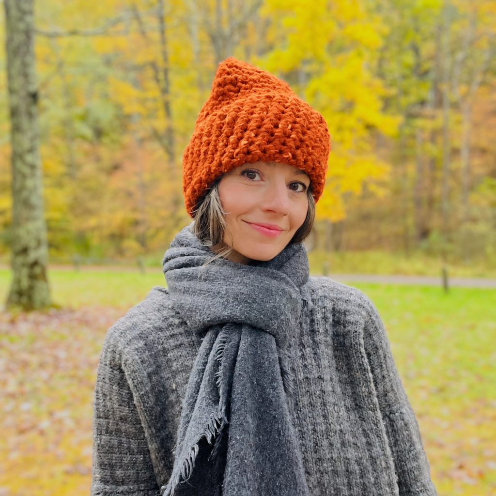 High Visibility Hat Colors available in North Ferry Unisex handmade Chunky Knit Winter Hats. Featuring Olivia the designer wearing the blaze orange while on a trail in the woods during hunting season