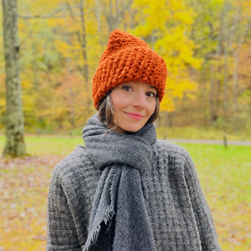High Visibility Hat Colors available in North Ferry Unisex handmade Chunky Knit Winter Hats. Featuring Olivia the designer wearing the blaze orange while on a trail in the woods during hunting season