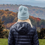 Person wearing a Mint Blue Chunky Knit Beanie with the cuff rolled up. 