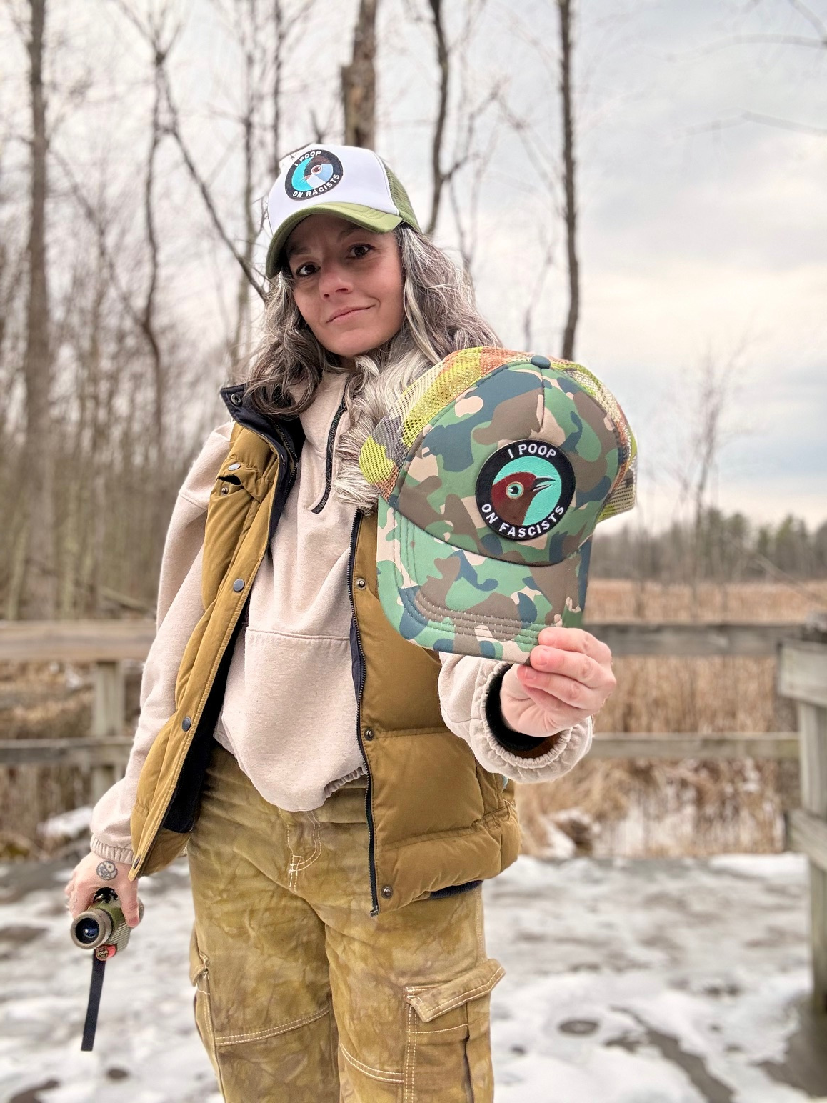 North Ferry Hats Activism Merch with I Poop on Racists Bird Baseball Caps and Trucker Caps, available in Green and Camo