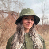 Reversible Bucket Hat flipped inside out to the green satin-blend lining side.  Both sides of these bucket hats are wearable and all-seasonal cotton or natural fiber