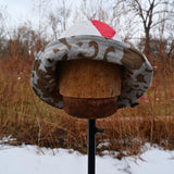 Sewing setup in a wood tiny house overlooking snowy woods scene. Sewing Bucket Hats in February for a sustainable hat company, available in spring reversible waterproof bucket hats and PACKABLE Sun hats made in the finger lakes