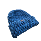 Blue knitted beanie on a white background