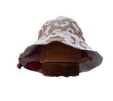 Sewing setup in a wood tiny house overlooking snowy woods scene. Sewing Bucket Hats in February for a sustainable hat company, available in spring reversible waterproof bucket hats and PACKABLE Sun hats made in the finger lakes