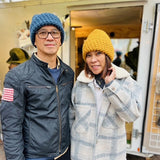Man and Woman both wearing North Ferry Beanies, in blue and in gold, these hats fit all sizes, are a cozy Chunky Knit Winter hat great for fall fashion and winter styles

