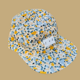 5 panel flat brim cap made with cotton print in yellow and green polka dot variations. Light and summer print 