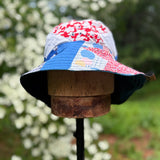Colorful bucket hats on a wooden block with a blurred natural background