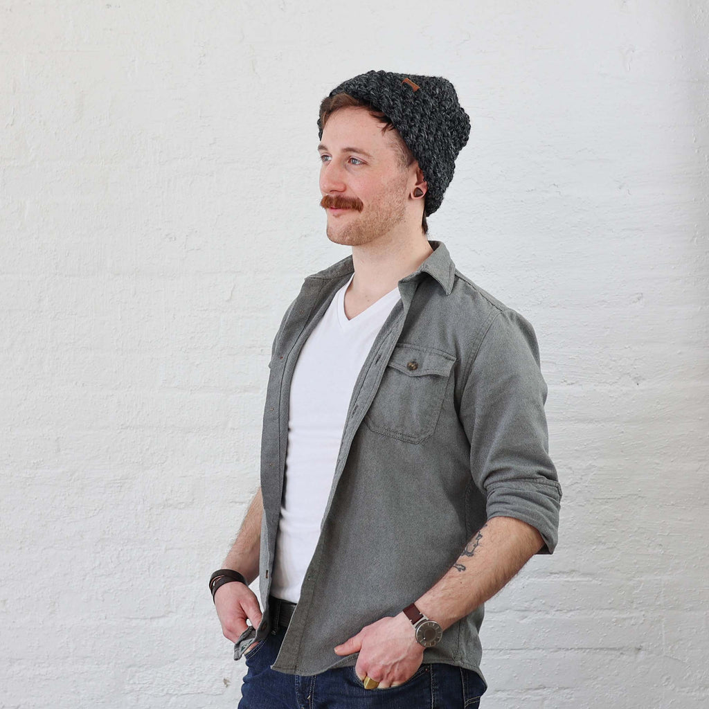 Charcoal Beanie on man that is folded up like a scullcap style, even though its a thick and tall beanie 