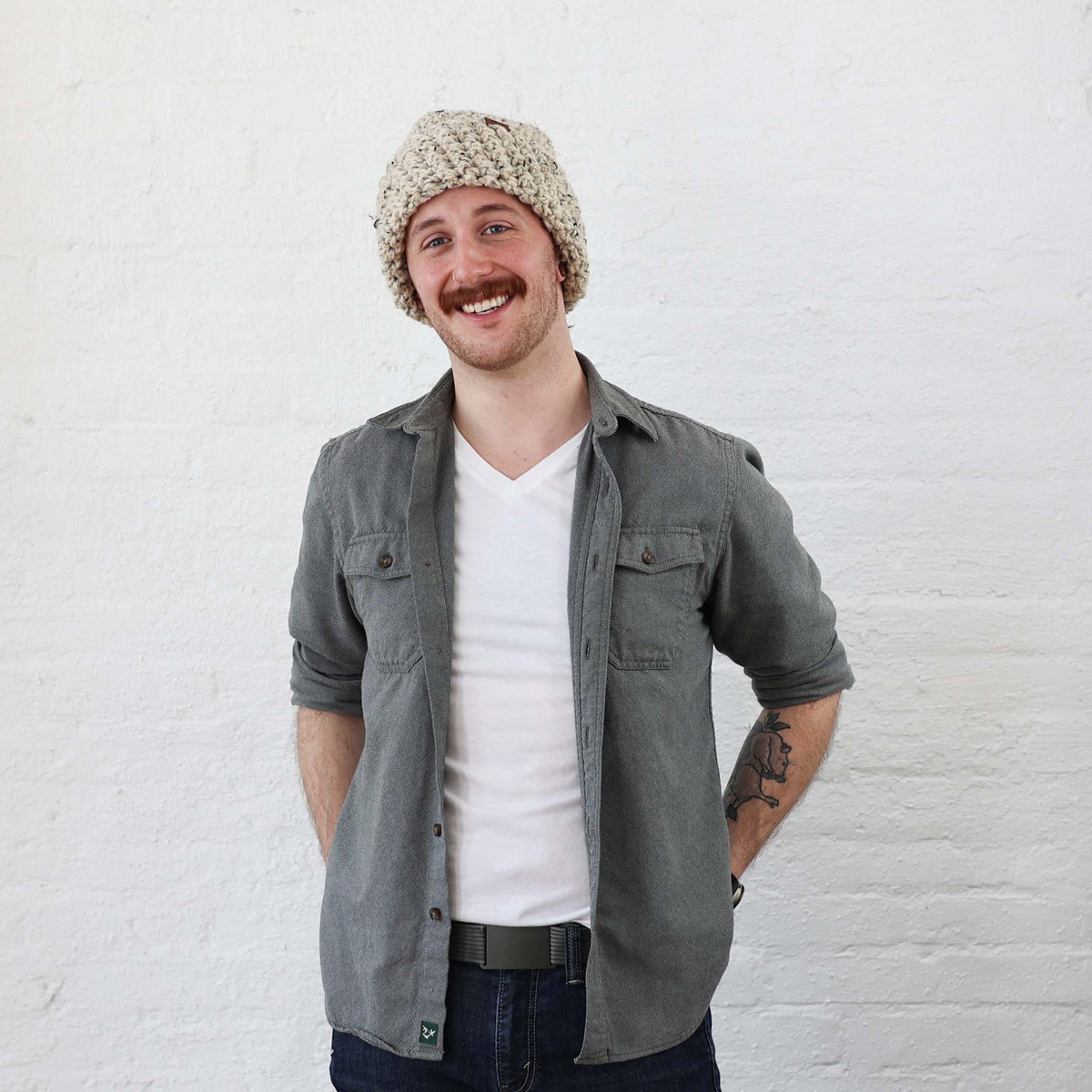 Thick Beanie styled on Man, Oatmeal Tweed with leather fold over tags. Fits like a skull cap with a wide cuff 