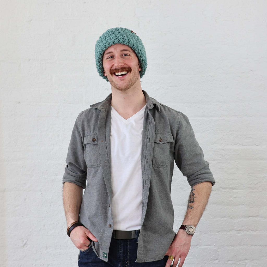 Light Blue Beanie styled on a Man, rolled up like a skullcap winter hat