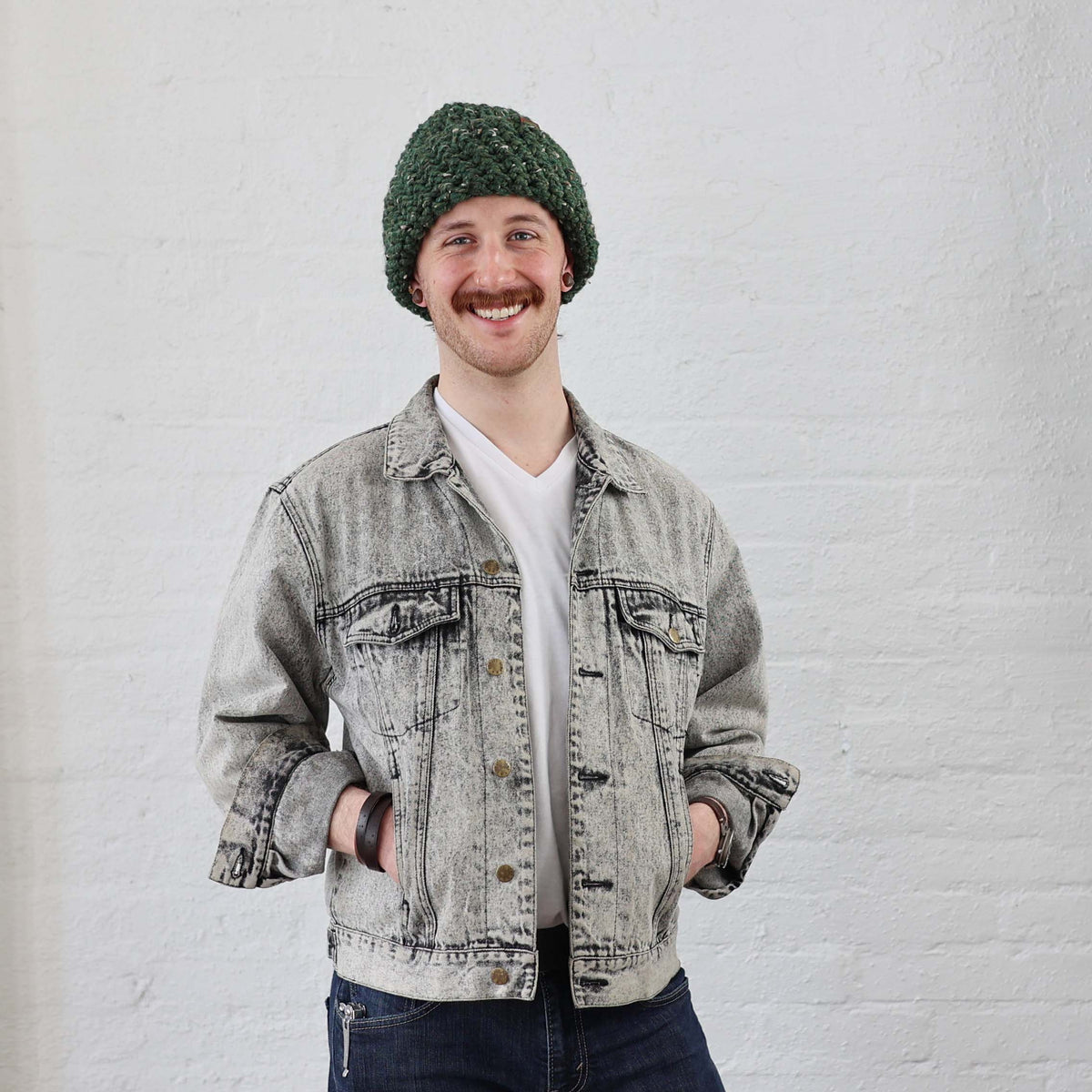 Thick Knit Green Beanie styled on Man with Cuff rolled up 