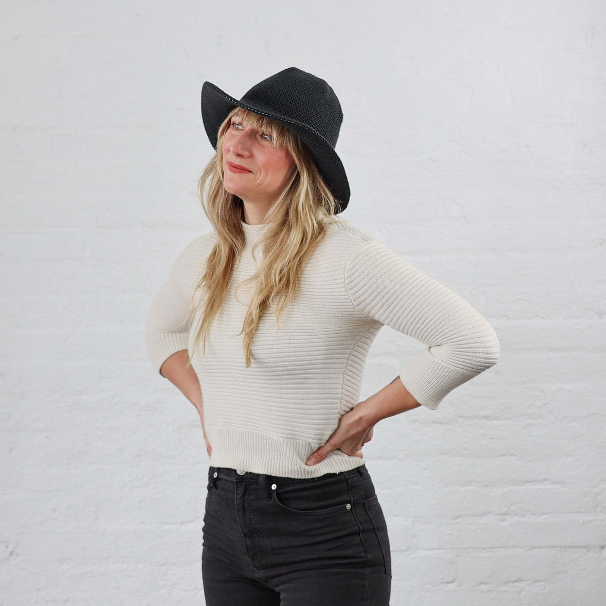 Black Wide Brim Floppy Brim Crochet Sun Hat models on woman with blond hair