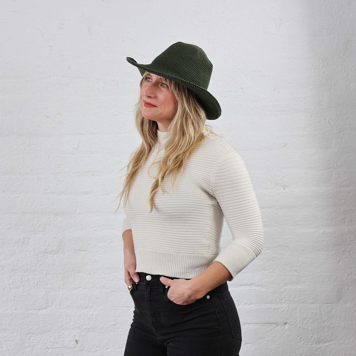 Leaf green Crochet Cotton Packable Sun Hat modeled on a women 