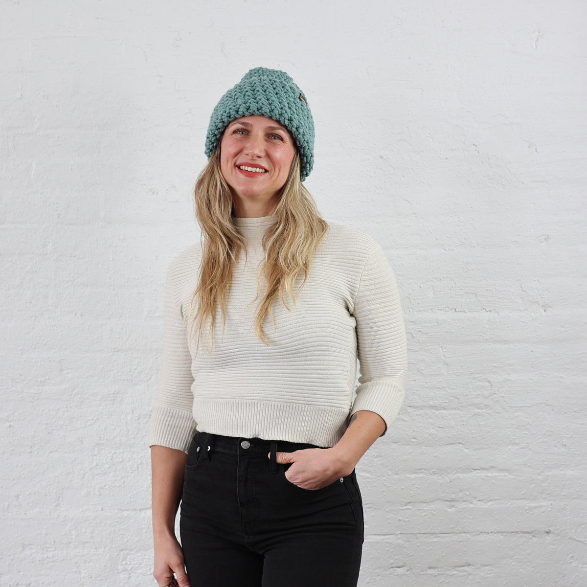 Light Blue Thick Knit Beanie styled on a  woman, folded up 