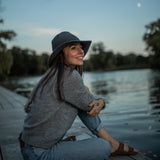 Wearing a comfortable, all-seasonal, Rain grey blue packable Sun hat during summer nights, watching the moon rise 